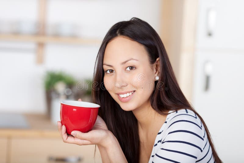 Smiling woman enjoying a cup of coffee stock photography