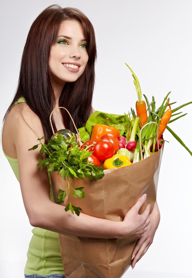 Smiling woman with fruits and vegetables.