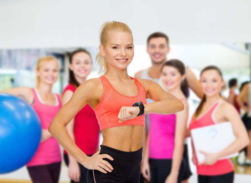 Smiling woman with heart rate monitor on hand stock photography Smiling woman with heart rate monitor on hand stock photography