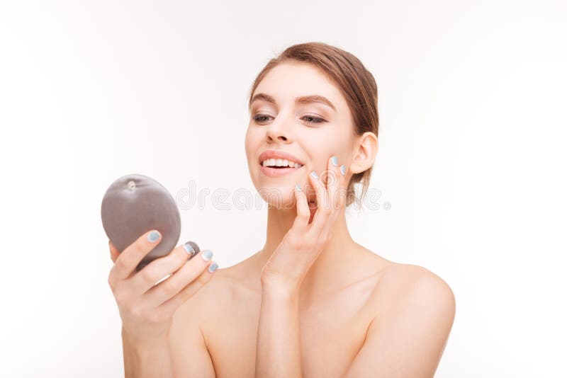 Smiling woman holding mirror