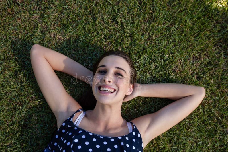 Smiling Woman Lying on Grass with Hands Behind Head Stock Image Image