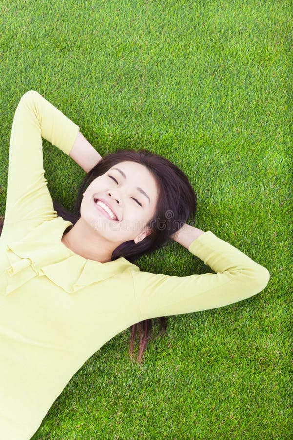 Smiling woman lying on the grassland