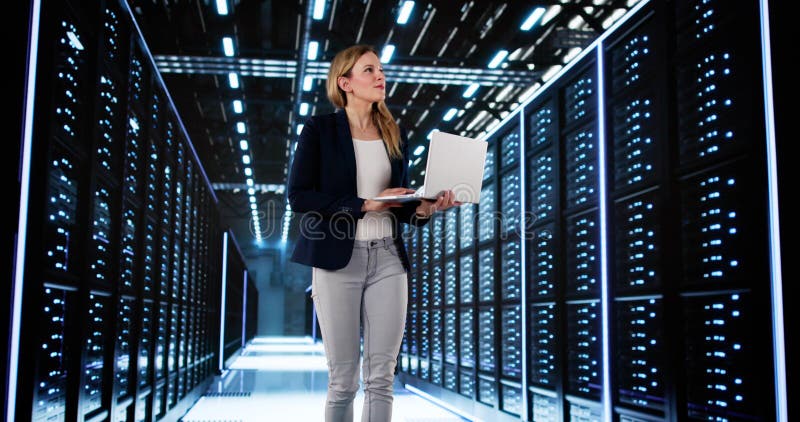 Smiling Woman Managing Data Center Server Room royalty free stock photo