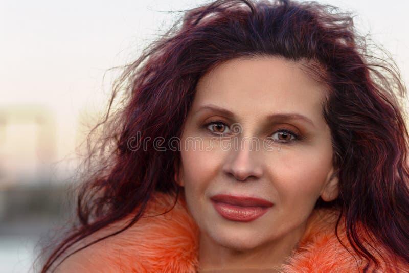 Smiling woman with orange fur royalty free stock photography