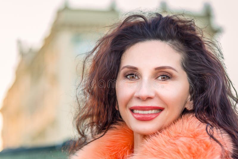 Smiling woman with orange fur royalty free stock photo