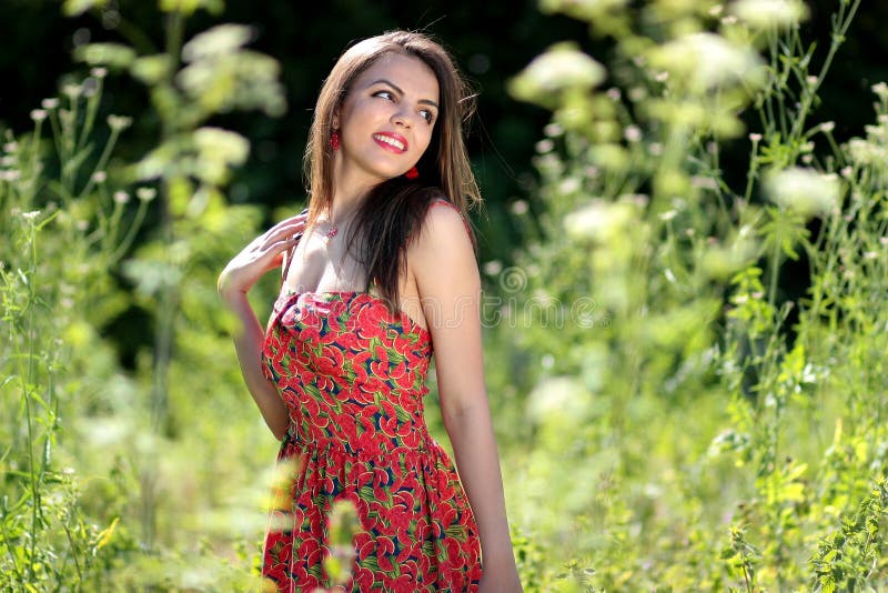 Smiling Woman In Pink Black And Green Floral Tube Dress Near Green Leaf Plants During Daytime Free Public Domain Cc0 Image