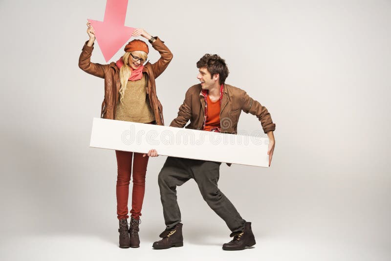 Smiling woman pointing on empty board royalty free stock image