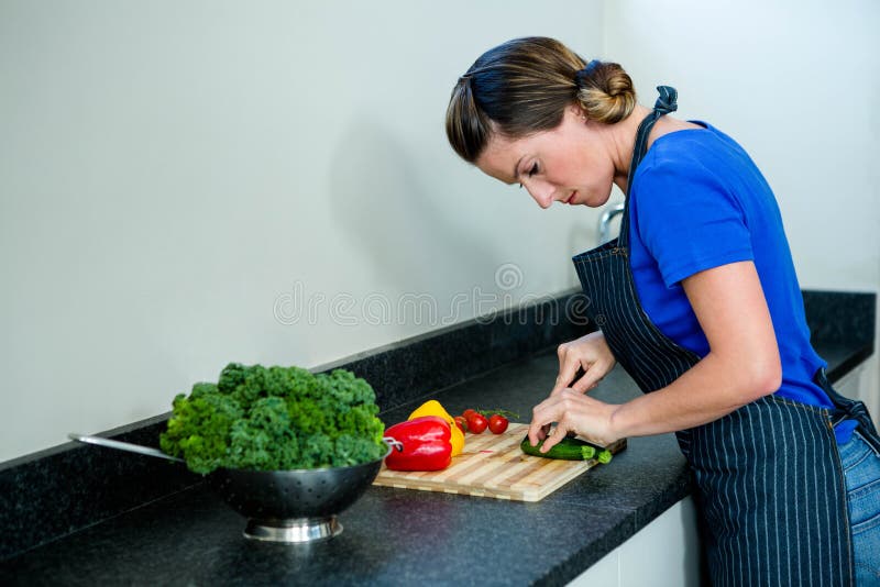 smiling woman preparing vegetables for dinner stock photo smiling woman preparing vegetables for dinner stock photo