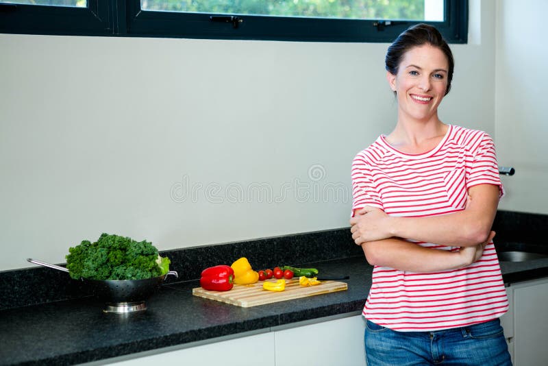 smiling woman preparing vegetables for dinner stock photo smiling woman preparing vegetables for dinner stock photo
