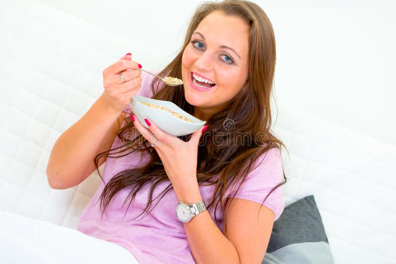 Smiling Woman Sitting on Sofa and Eating Muesli Stock Photo Image of comfort, 18550276