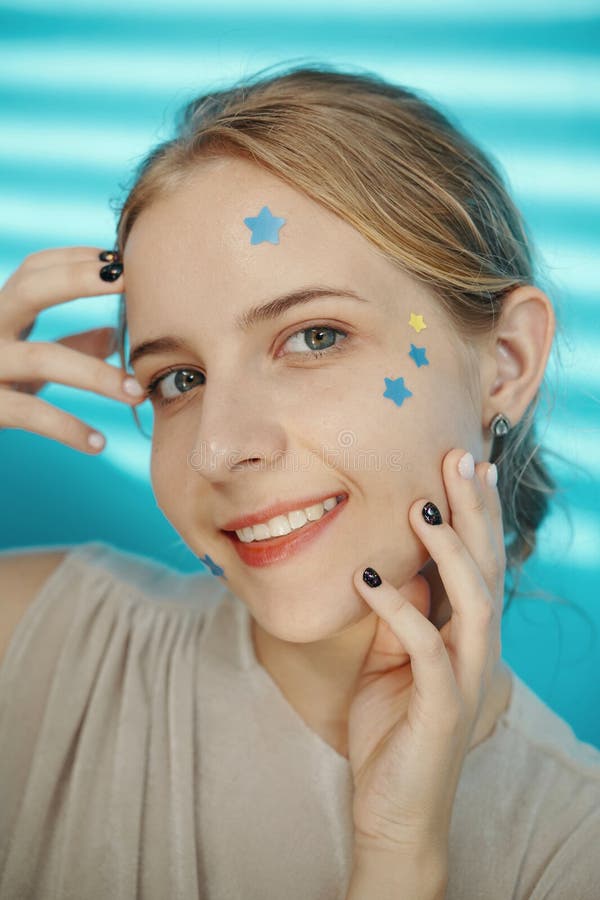 Smiling Woman with Star Stickers on Her Face royalty free stock image