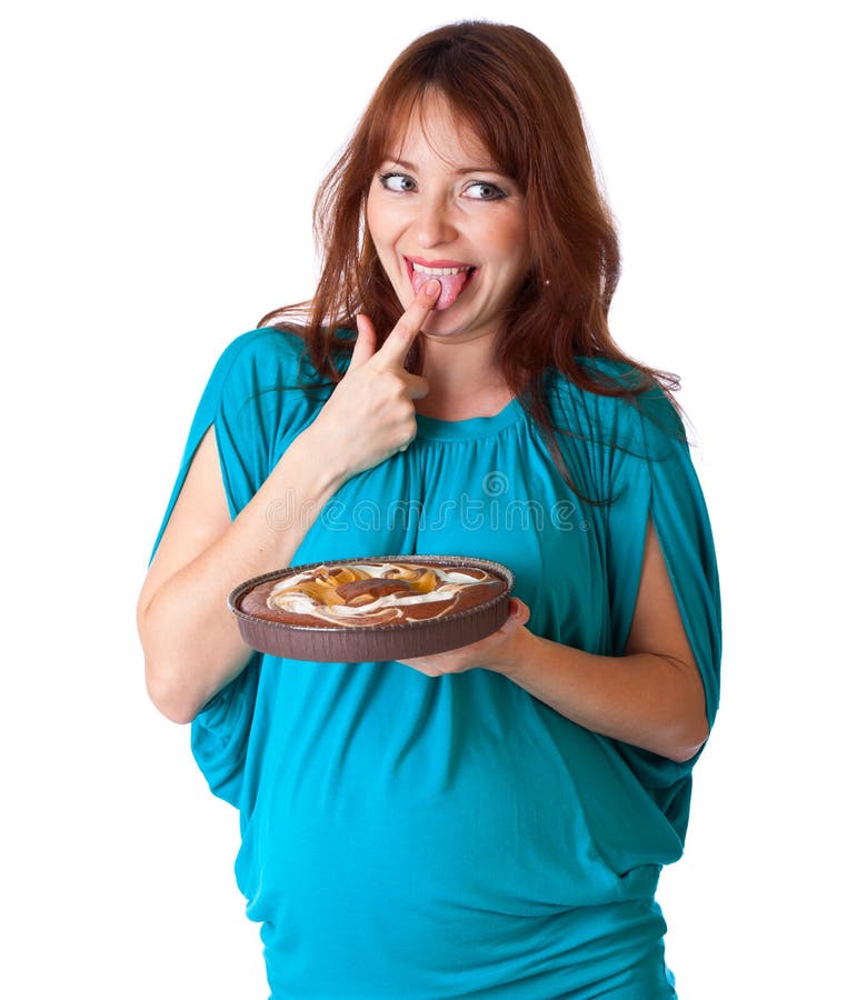 A smiling woman is tasting the cake