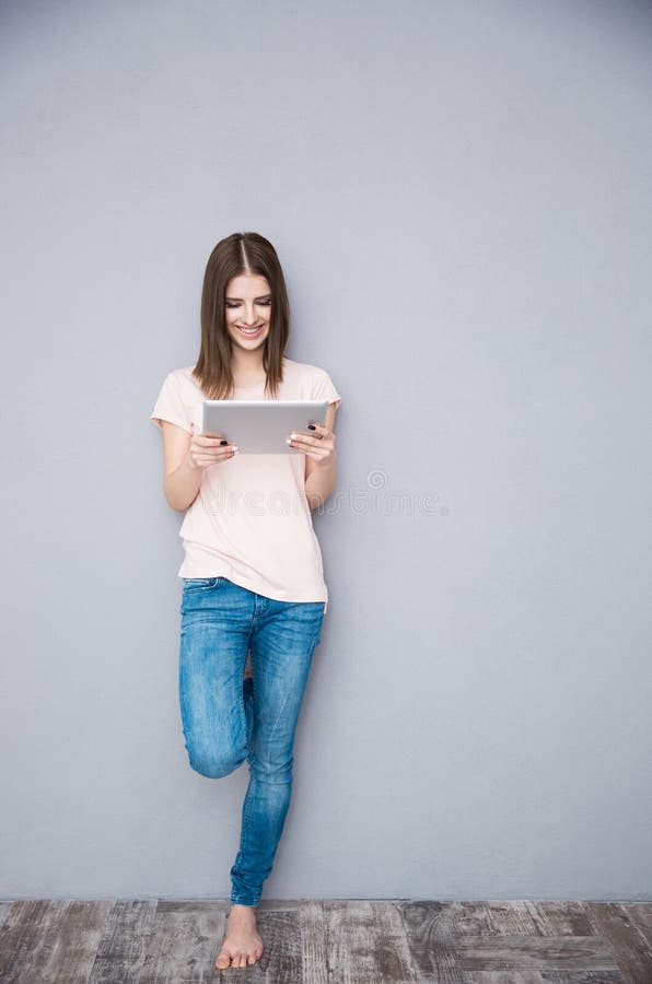 Smiling woman using tablet computer stock image Smiling woman using tablet computer stock image
