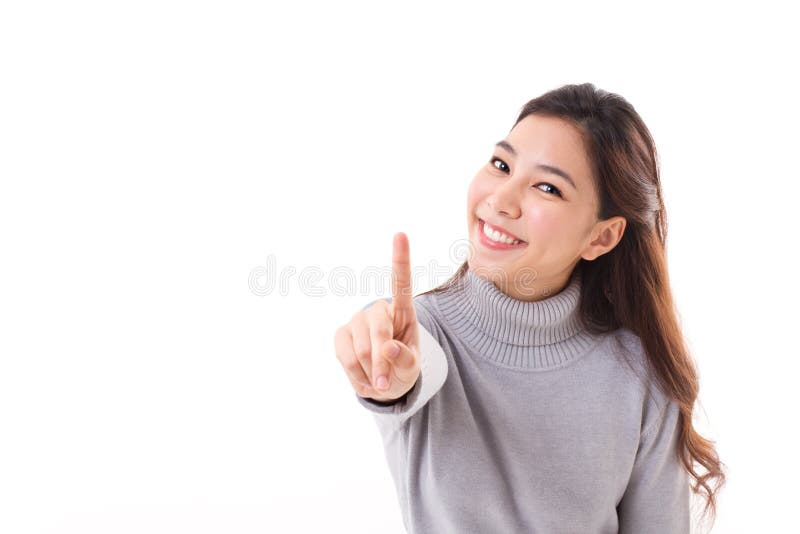 Smiling woman in winter outfit showing no.1 or one finger gesture