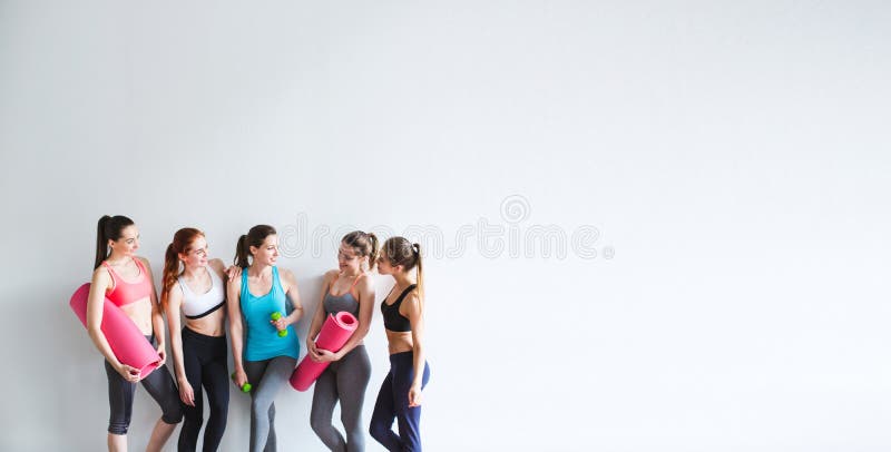 Smiling women yoga / fitness class.