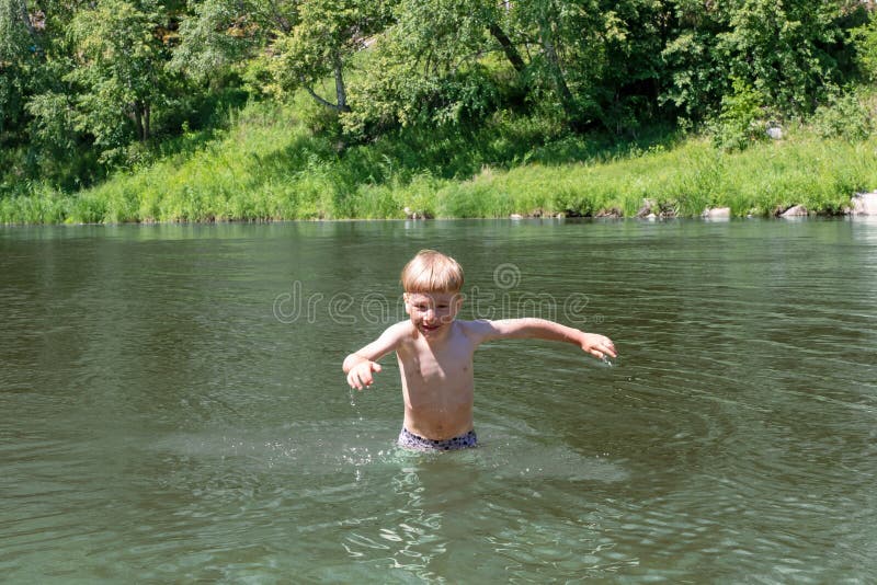 Smiling 5 Year Old Kid is Happy To Bathe in the Sea or River. the Child in  the Summer Plays in the Water Stock Image - Image of playful, game:  157477529