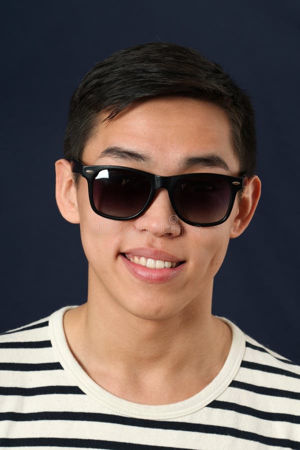 Smiling young Asian man in sunglasses