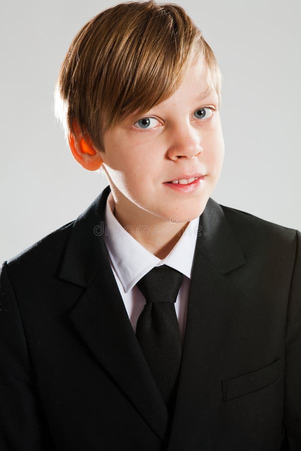 Smiling young boy wearing black suit