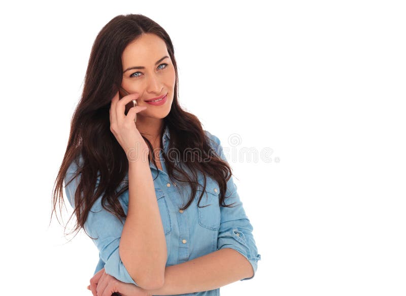 Smiling young casual woman speaking on the phone