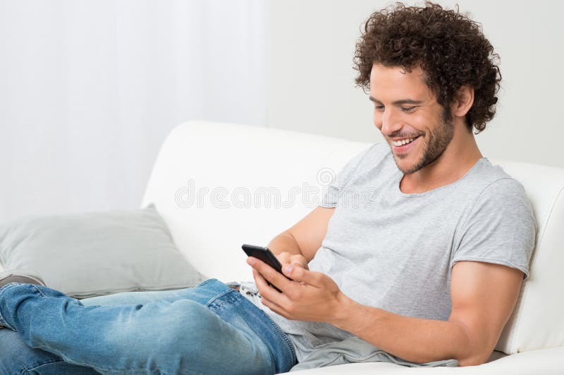 Smiling Young Man Holding Cellphone