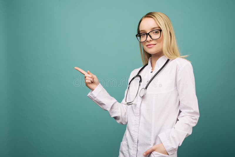 Smiling young medical doctor woman with stethoscope pointing on copyspase stock photo Smiling young medical doctor woman with stethoscope pointing on copyspase stock photo