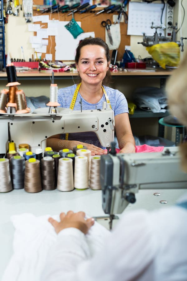 Smiling Young Professional Female Tailor Using Sewing Machine Stock ...