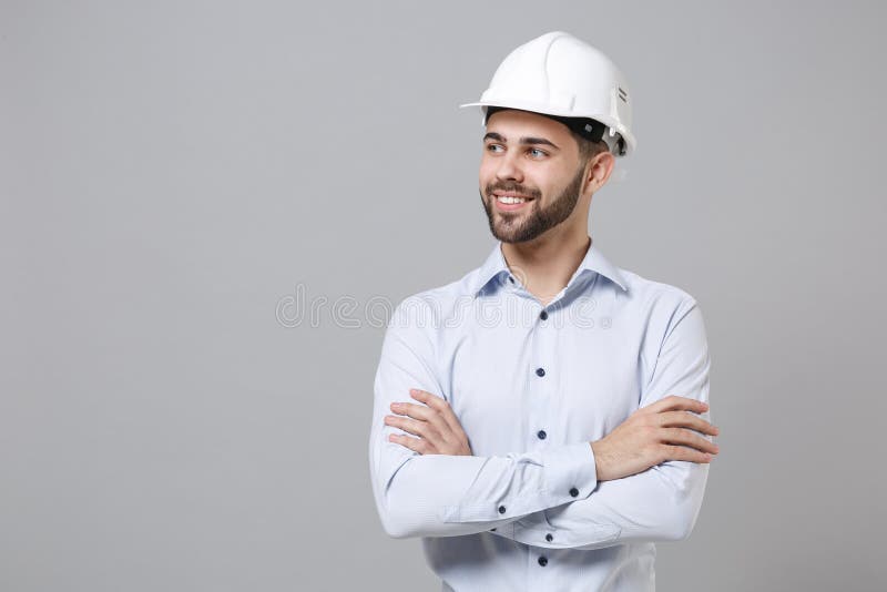 Download Smiling Young Unshaven Business Man In Light Shirt Protective Construction Helmet Isolated On Grey Wall Background Stock Image Image Of Occupation Mockup 191657197