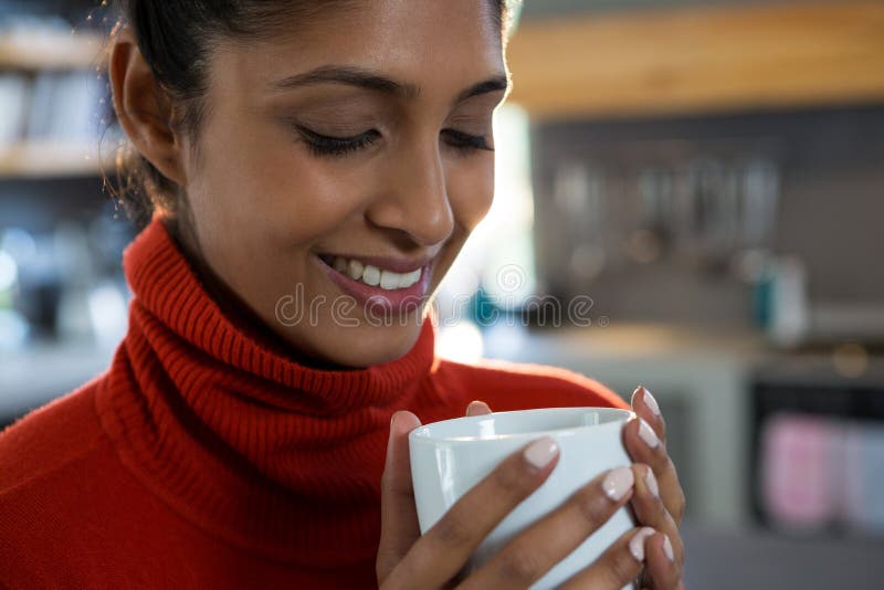 Smiling young woman having coffee stock photo Smiling young woman having coffee stock photo