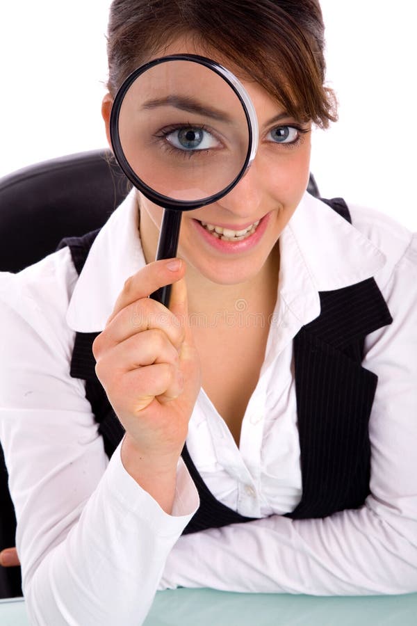 Smiling young woman holding magnifier