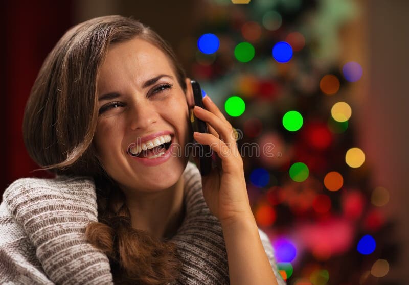 Smiling young woman speaking mobile phone