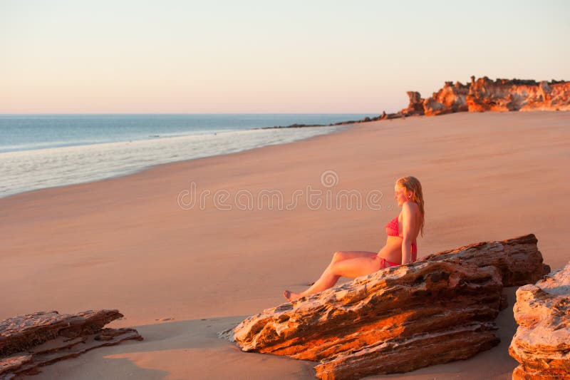 Smiling young woman tropical beach sunset