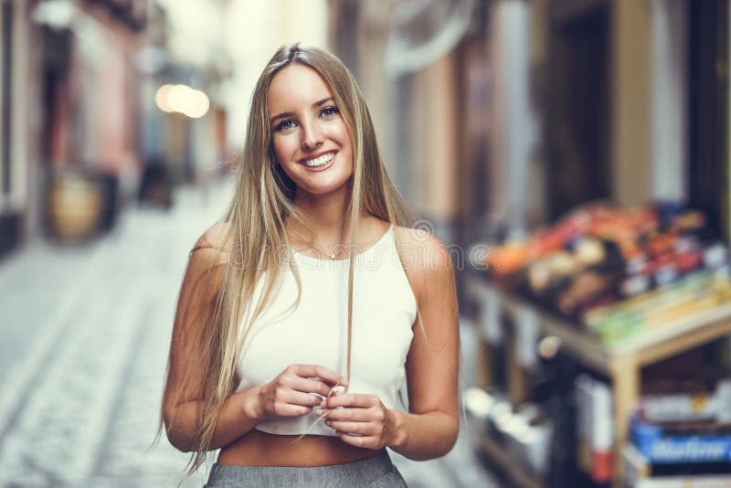 young woman in urban background wearing casual clothes - a Royalty