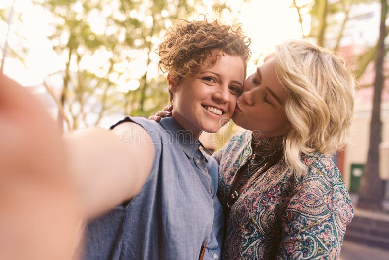 Affectionate Young Lesbian Couple Taking A Selfie Together Outside