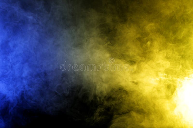 Smoke in Blue Yellow Light on Black Background in Darkness Stock Image
