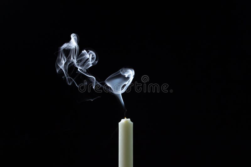 Smoke from a Candle on a Black Background. an Extinguished Candle on a