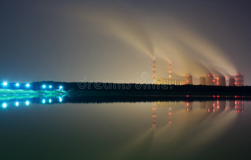 The smoke from the chimneys of a power plant royalty free stock image