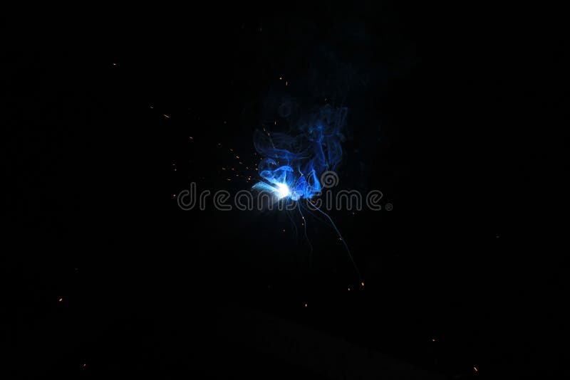 Fire and Sparks from Under the Burning Welding Electrode Stock Image