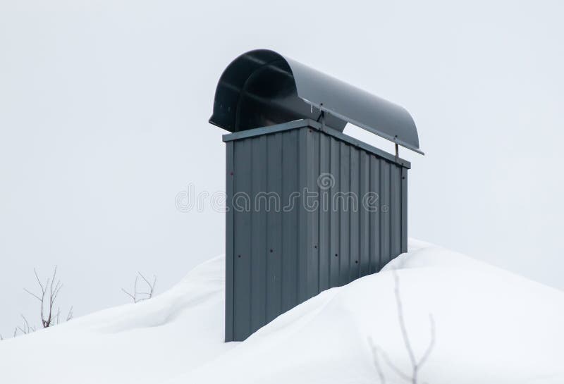 Smoke, Rectangular, Black Exhaust Pipe on the Roof of a Modern House