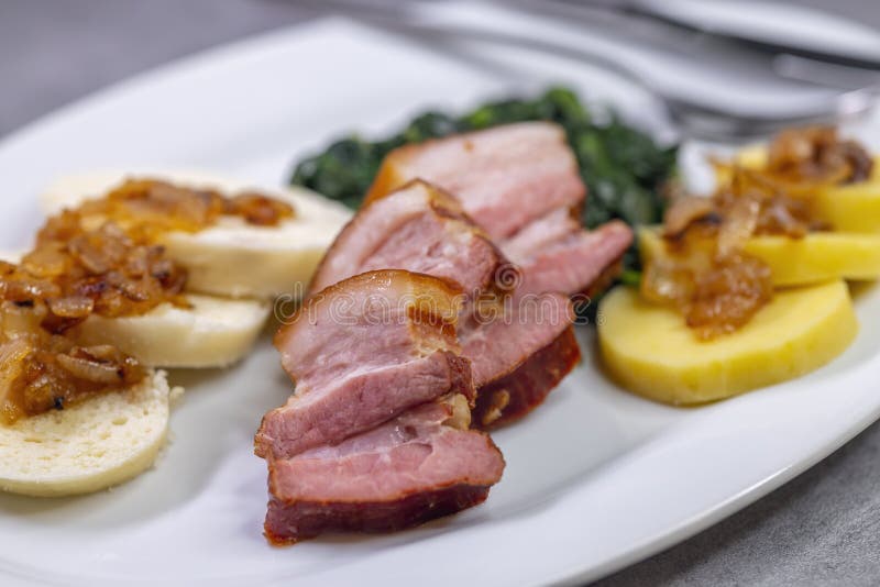 Smoked Flank with Potato and Bread Dumplings and Spinach Stock Image