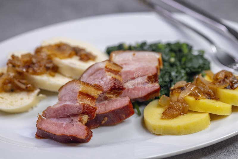 Smoked Flank with Potato and Bread Dumplings and Spinach Stock Image