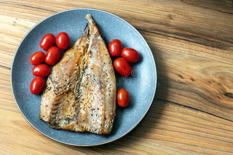 Smoked Mackerel Fish Fillet with Tomatoes on a Plate Stock Image