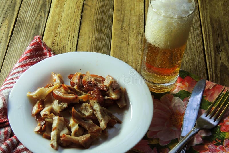 Smoked pig ears. Beer stock image. Image of plate, brown 92135601