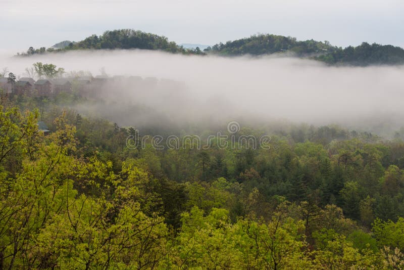 Foggy view of cabins on a cloudy early morning in the Great Smokey Mountains, Tennessee. Foggy view of cabins on a cloudy early morning in the Great Smokey Mountains, Tennessee.