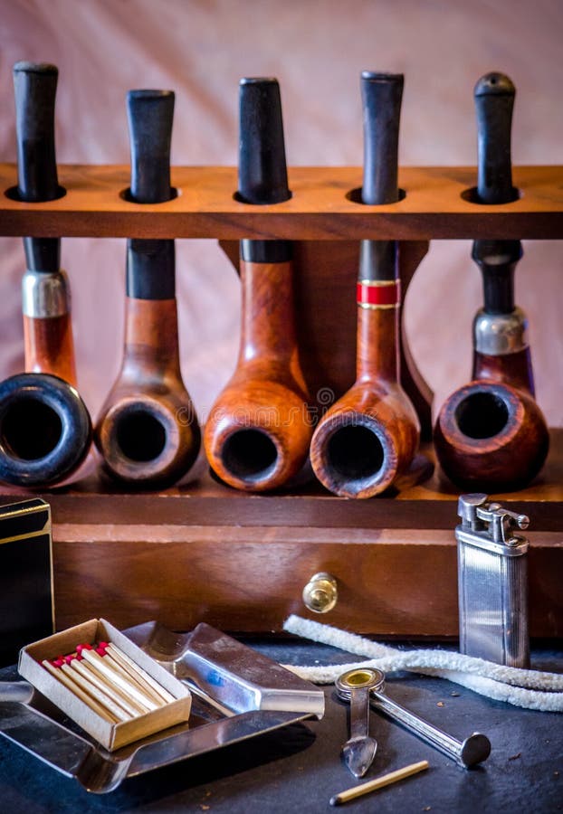 Smoking Accesories And Tobacco Pipes On A Wood Pipe Rack Stock