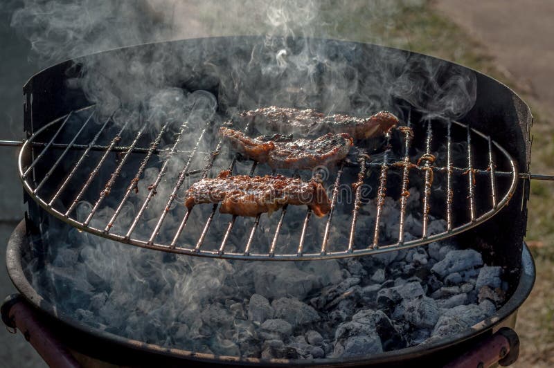 Smoking charcoal barbecue. stock photo. Image of cooking 136911550