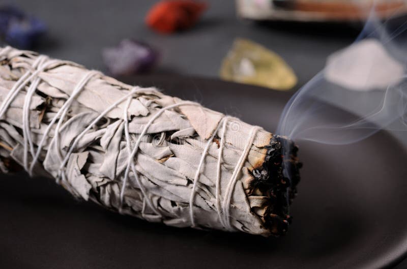 Smoking herbal incense White Sage. royalty free stock photography