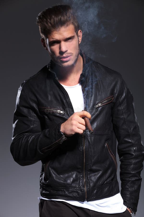 Smoking young man in leather jacket. 