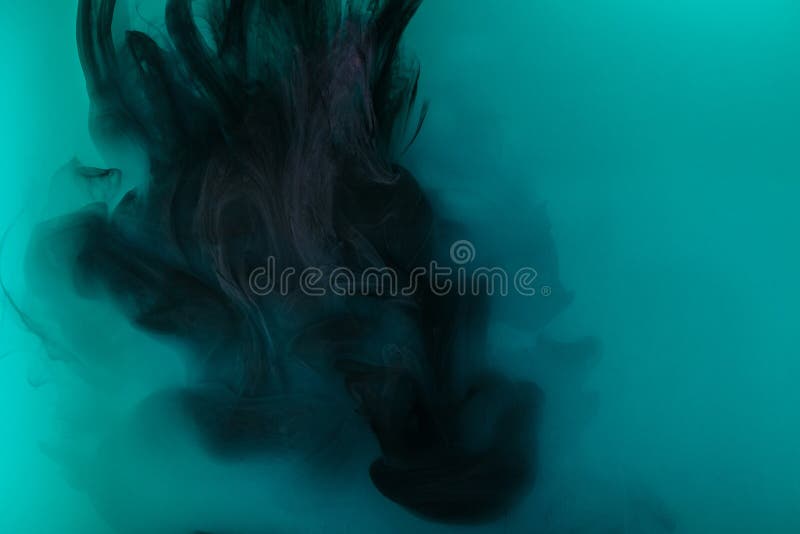 Smoky background with black paint in turquoise water