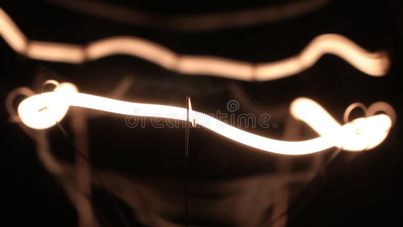 Smooth increase and decrease in the power of the helix of the tungsten filament. Close-up tungsten filament retro lamp. Decrease video