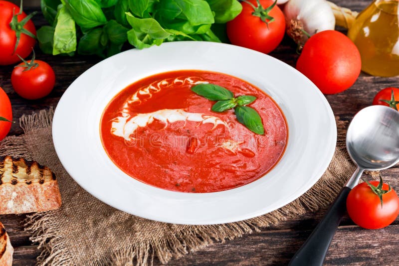 Smooth and sweet tomato soup, seasoned with basil, garlic. 